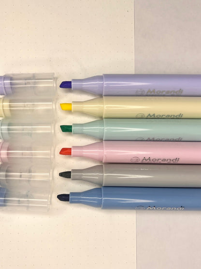 Morandi highlighter pens with open caps kept on a white sheet with grey background now available at Point Blank at the cheapest prices